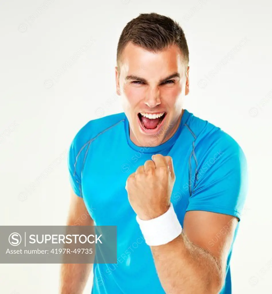 Portrait of a young male tennis player celebrating a victory