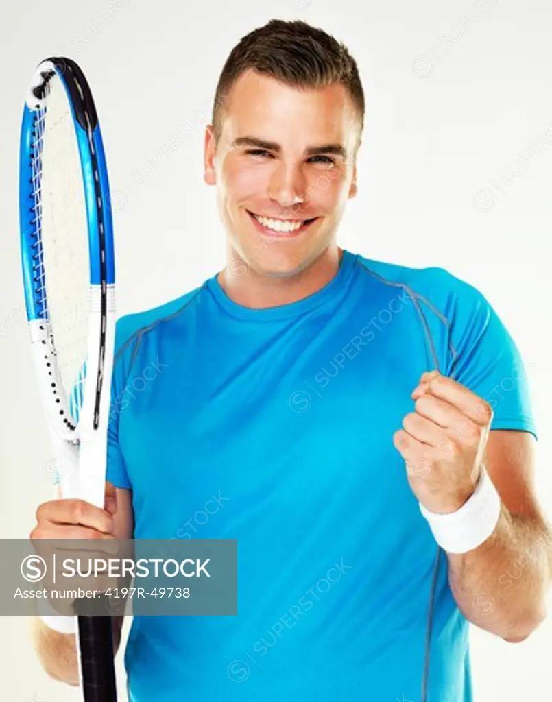 Portrait of a young male tennis player celebrating a victory