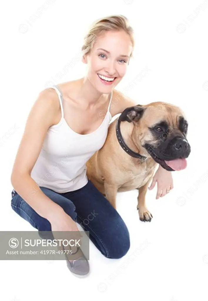Pretty young woman smiling at you with her arm around her bull mastiff - isolated