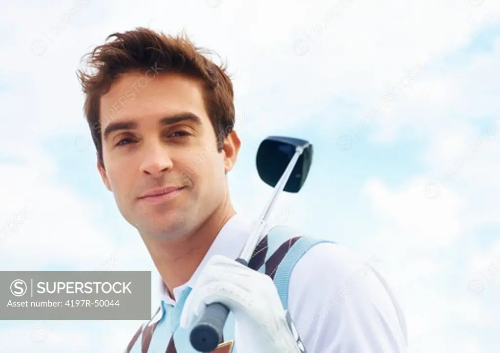 Portrait of a handsome and proud young golfer holding his club - Copyspace