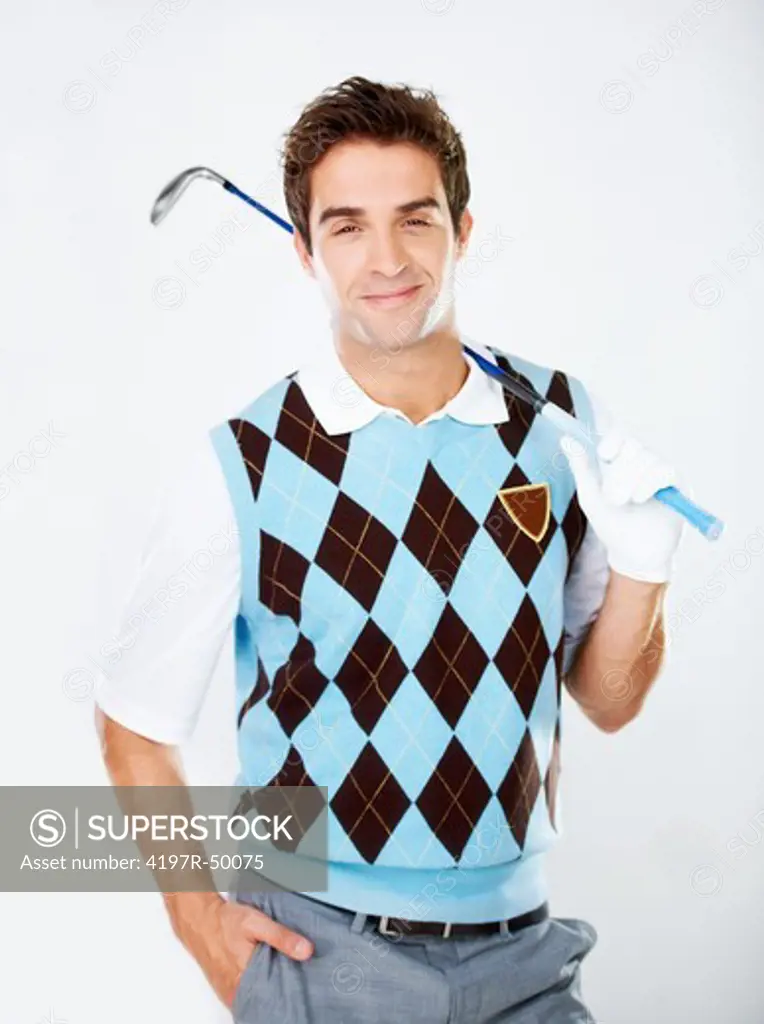 Handsome young golfer holding his club over his shoulder while isolated on white
