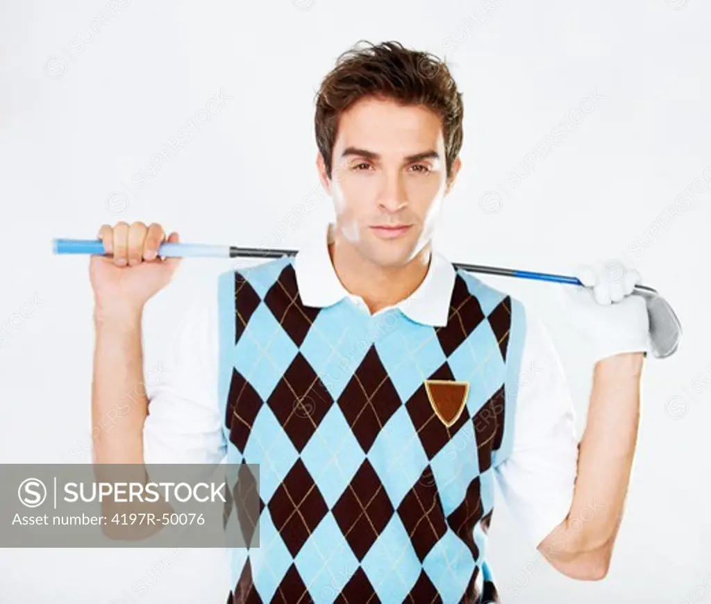 Suave golfer holding his club while isolated on white