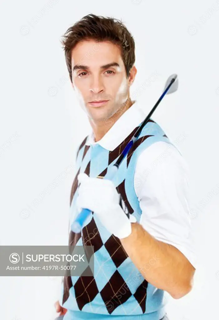 Portrait of a handsome young golfer holding his club over his shoulder while isolated on white