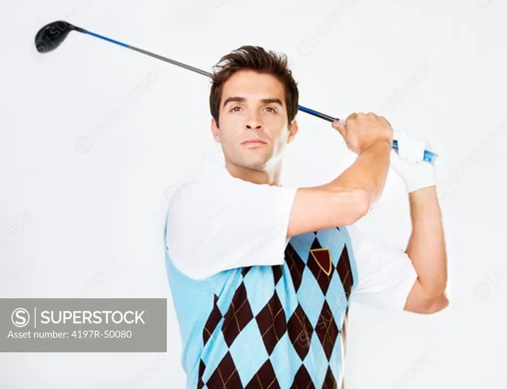 Young golfer swinging his club while isolated on white