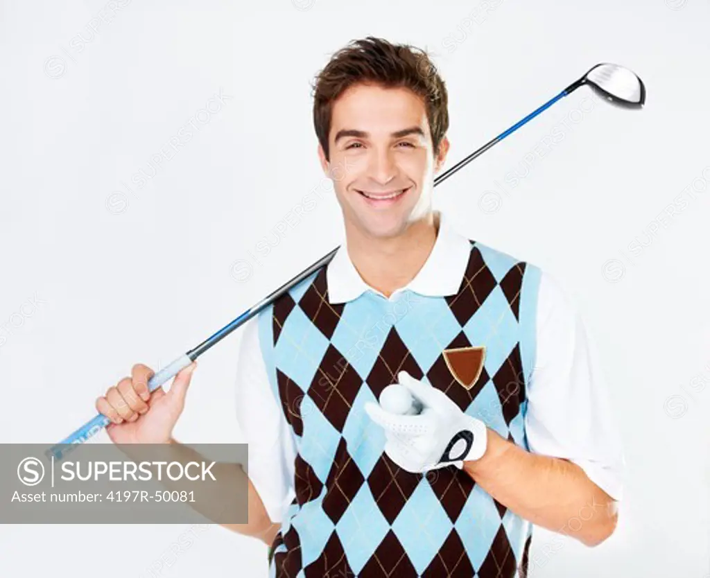 Happy young golfer holding his ball and club while isolated on white