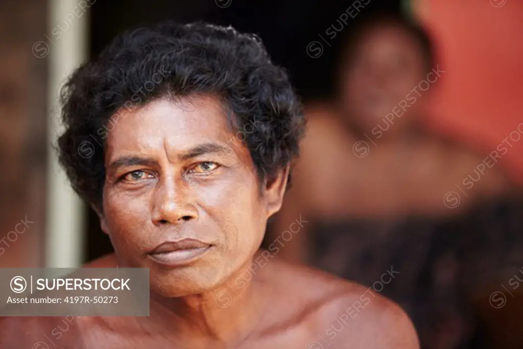 Portrait of a middle-aged Thai man staring at the camera