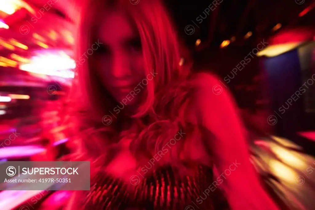 Blonde transgender woman in nightclub - motion blur