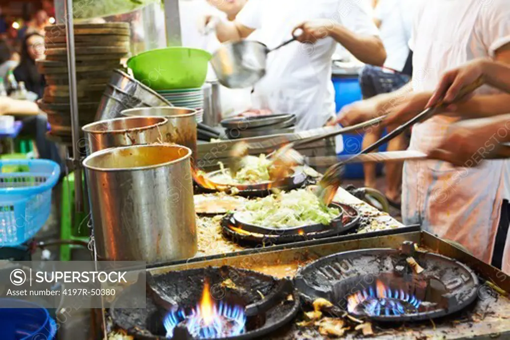 Preparing food at a busy Thai restaurant