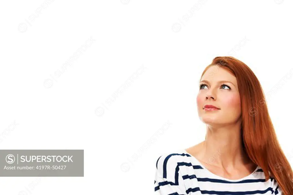 A gorgeous redhead gazing into the copyspace - Isolated