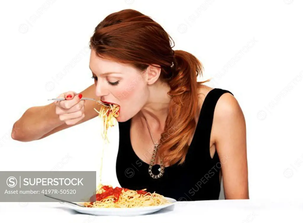 A young woman trying to eat her spagetti without making a mess