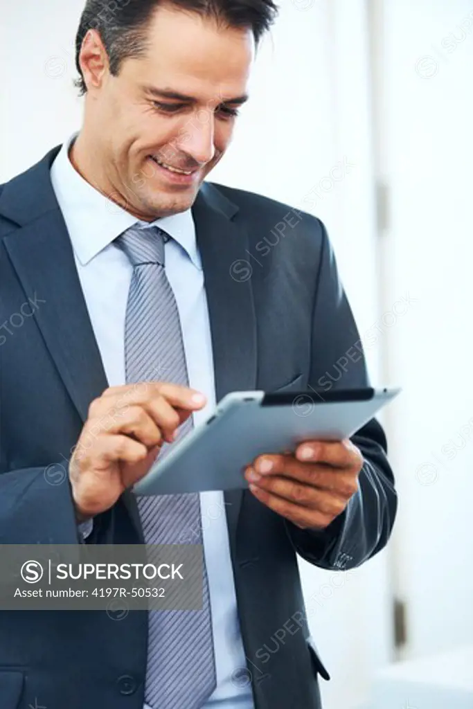 Handsome businessman using his digital tablet