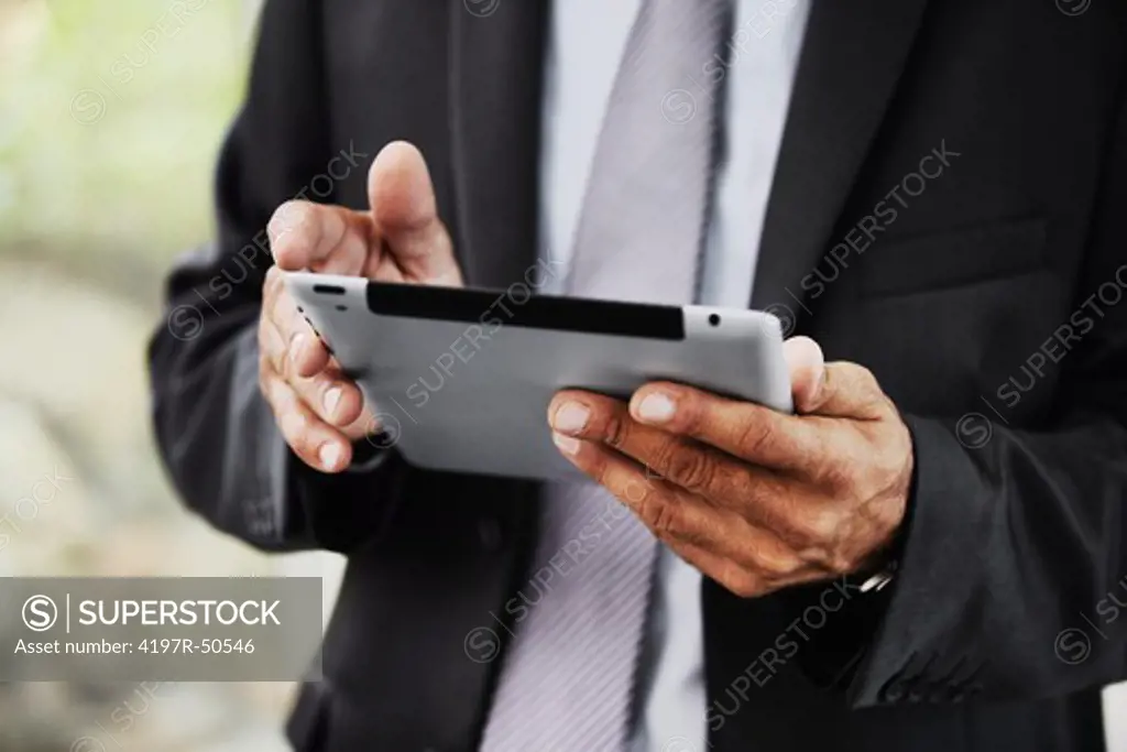 Cropped image of a businessman holding a digital tablet