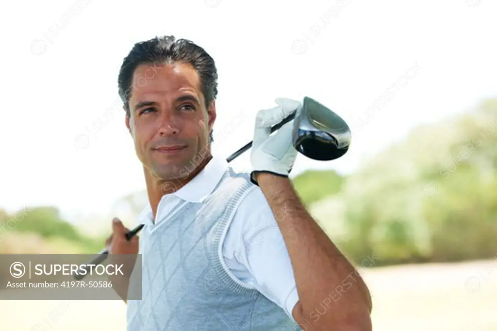 Portrait of an assured and confident mature golfer with his club along his shoulders