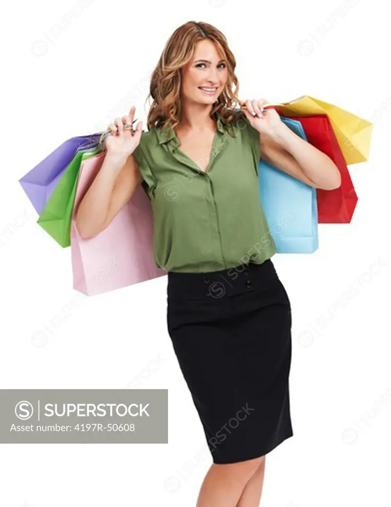 A pretty young woman posing happily after a successful shopping spree