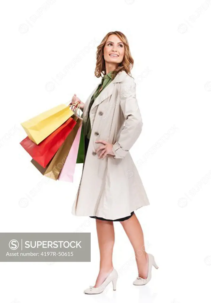 Sophisticated beauty carrying a trio of colourful shopping bags