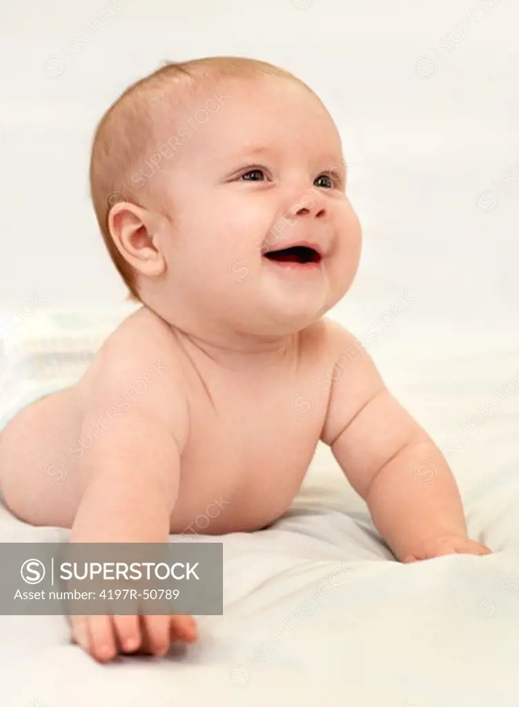 Adorable laughing baby boy on a white background
