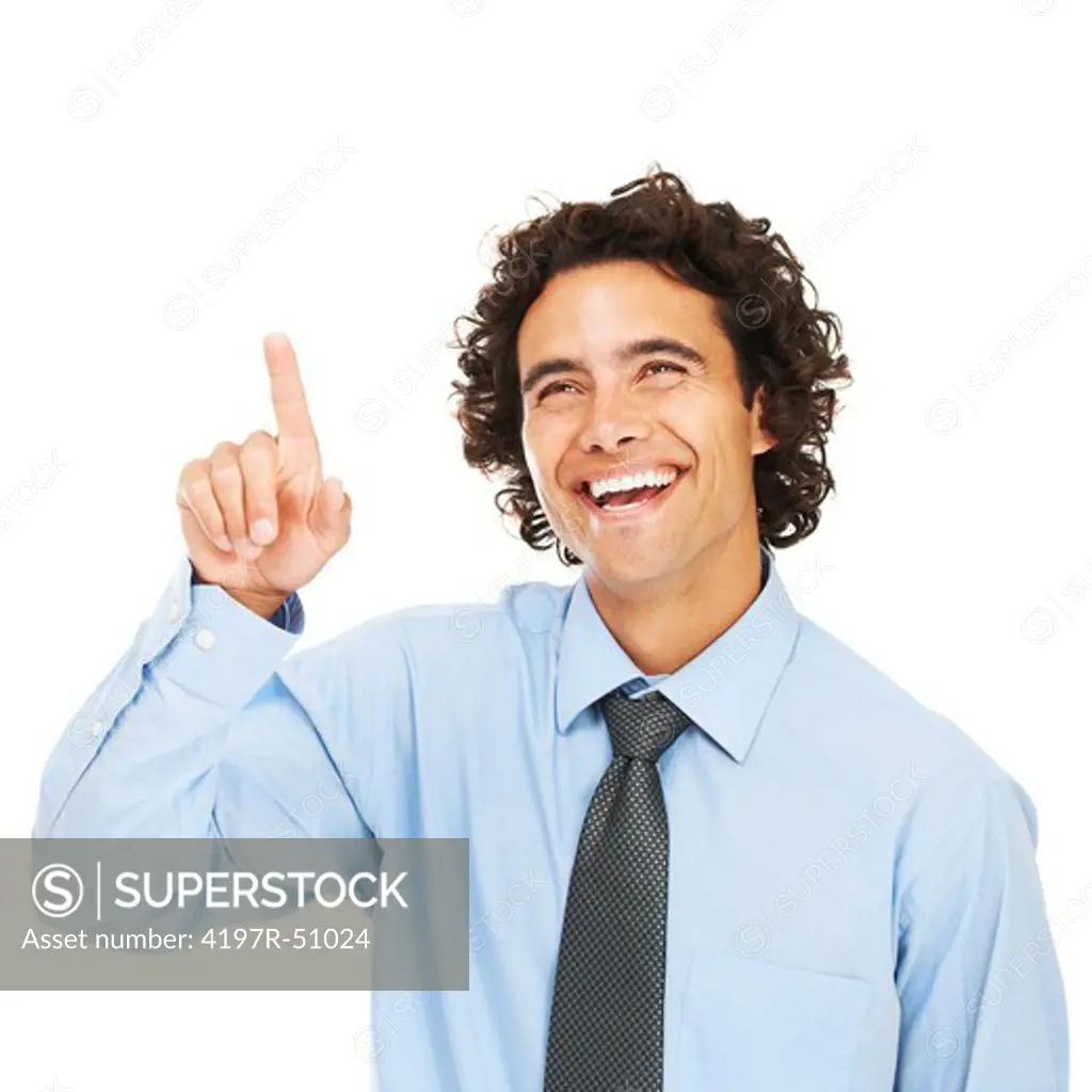 A young businessman pointing up towards the copyspace