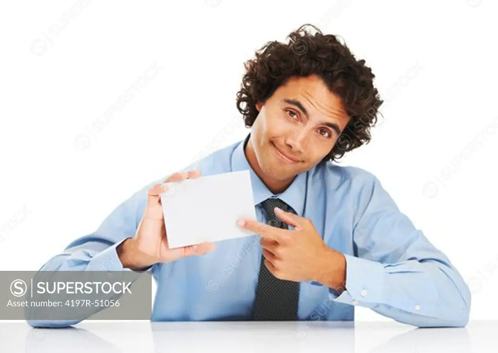 Portrait of a young businessman pointing to a blank card
