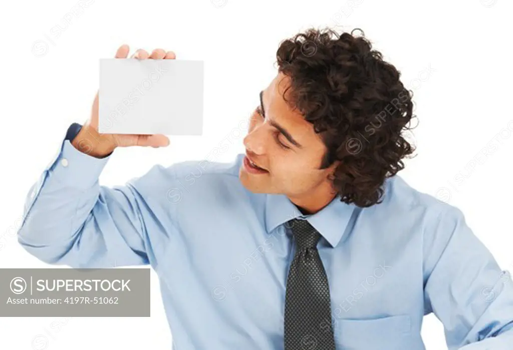 A young businessman looking at a blank card