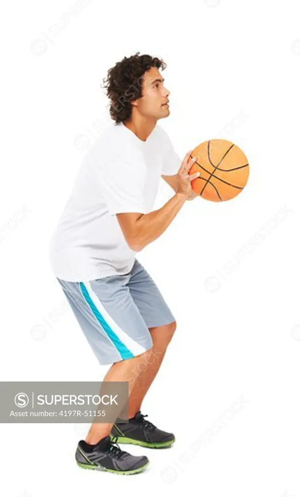 Profile of a young man about to take a shot with a basketball