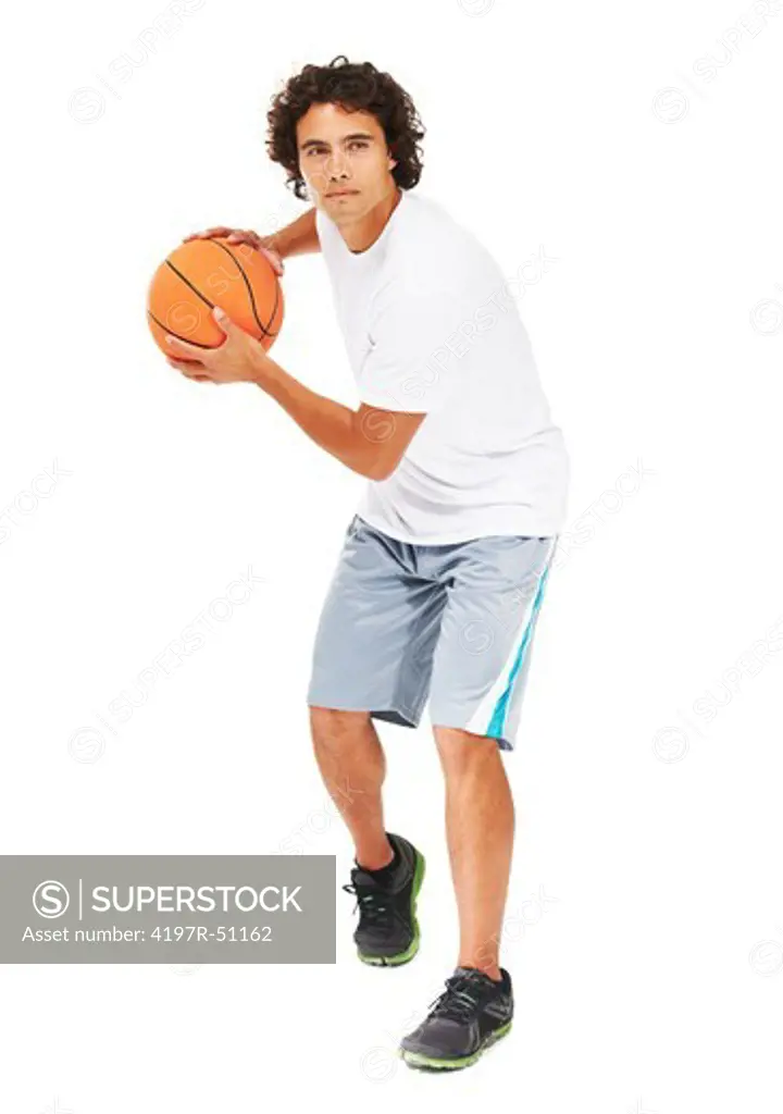 A young man standing with a basketball