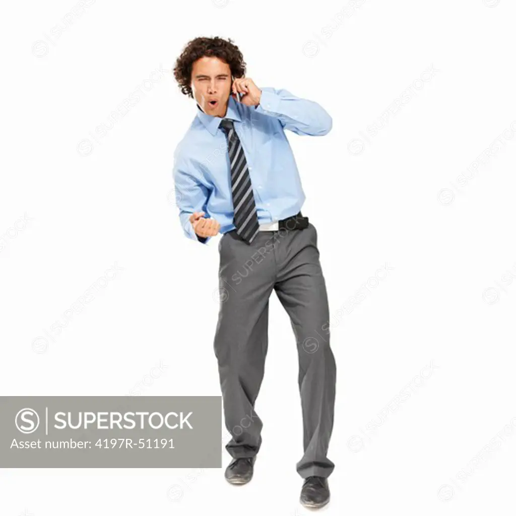 Excited young businessman on call and receiving some good news