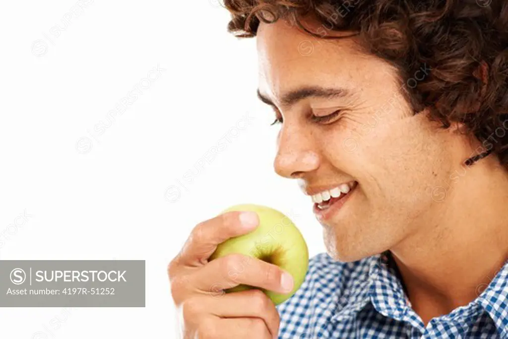 Young man about to take a bit out of a delicious apple  - Copyspace