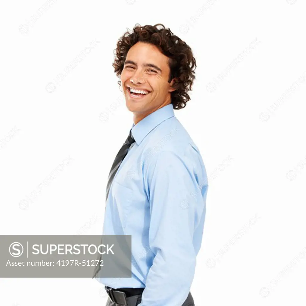 Relaxed businessman with his hands in his pockets and isolated on white