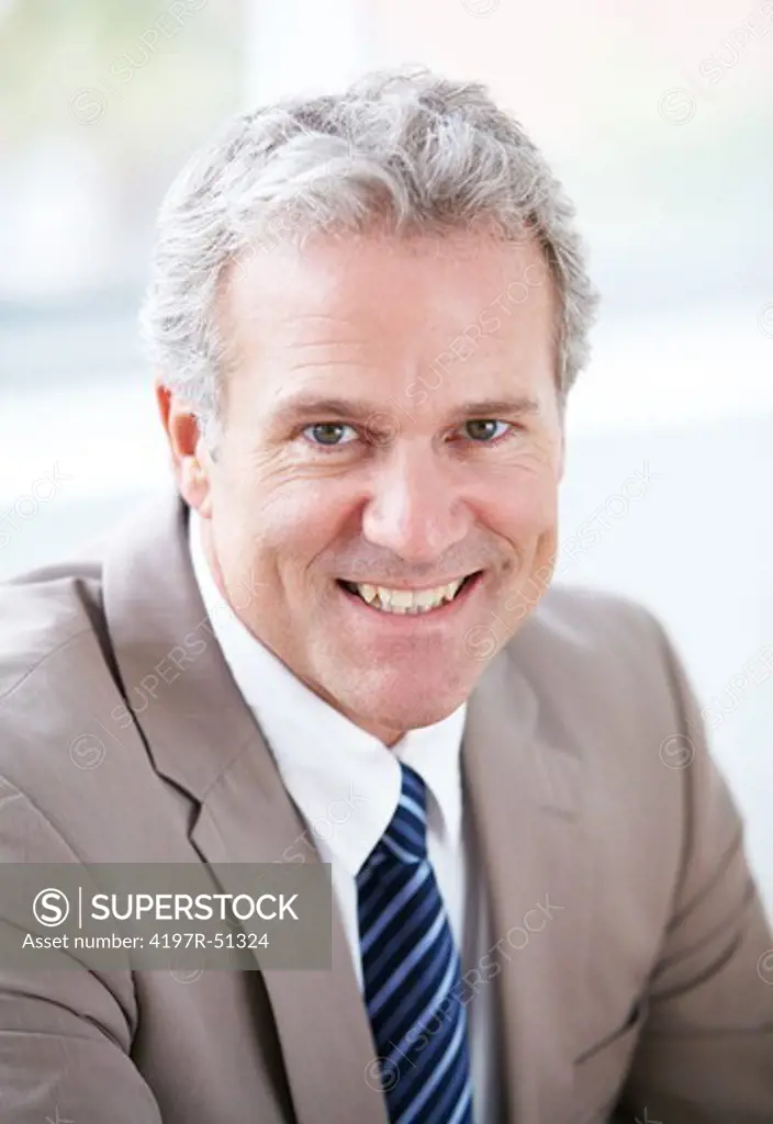 Closeup of a mature businessman smiling at the camera - portrait