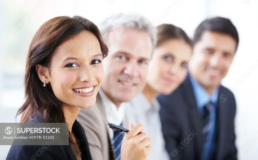 Group of happy business colleagues sitting in a row and smiling at the camera - portrait