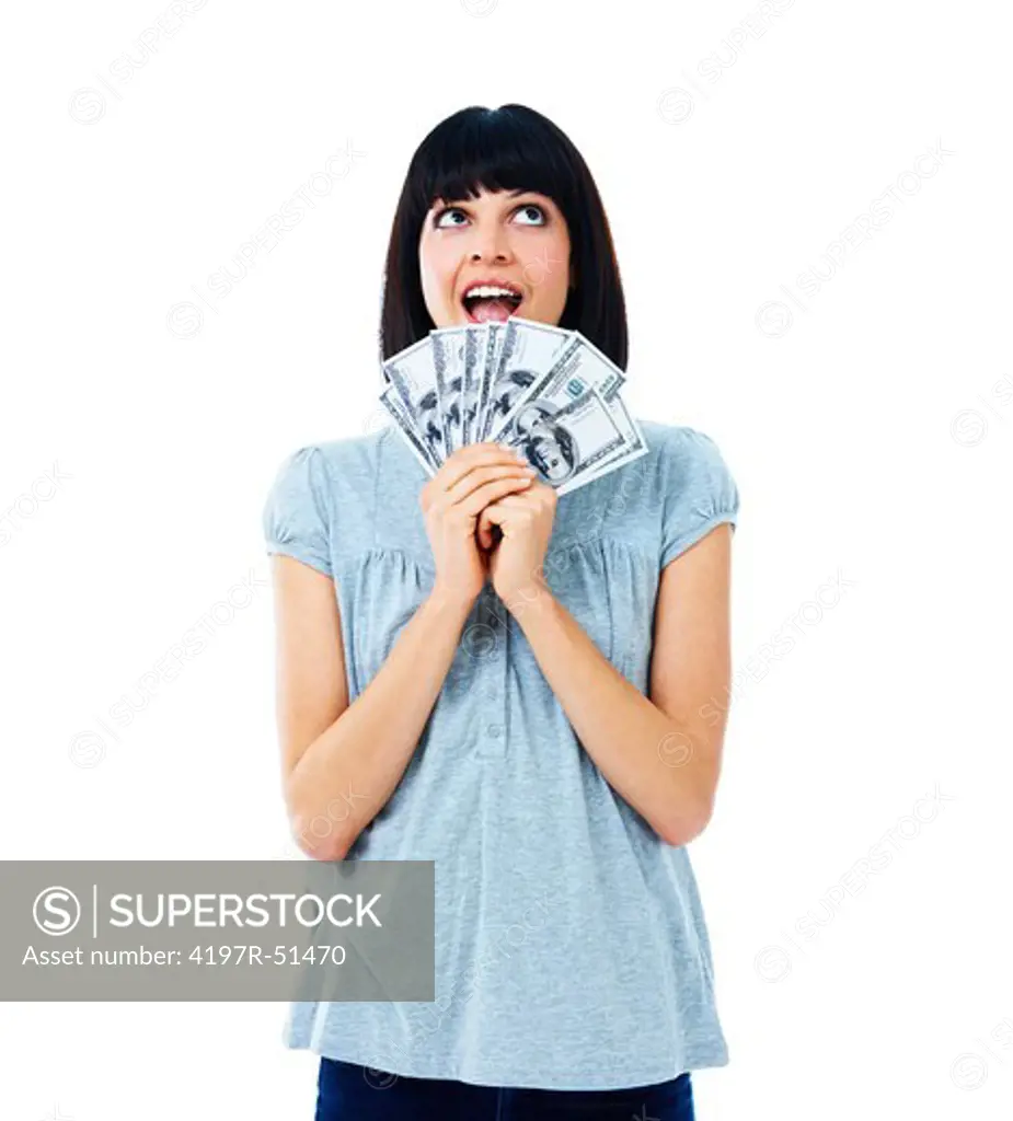Pretty young woman holding a bundle of cash, thinking excitedly how she will spend it