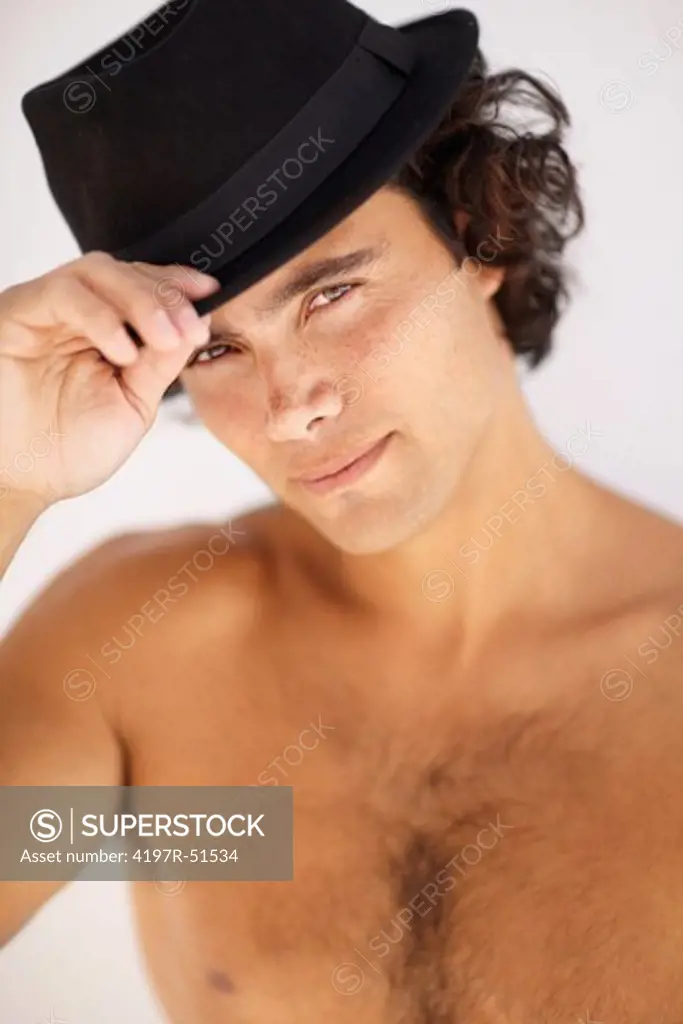 Suave and sexy young man wearing a black hat - portrait