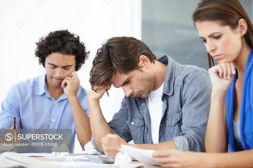 Frustrated businesspeople concentrating and trying to solve a problem