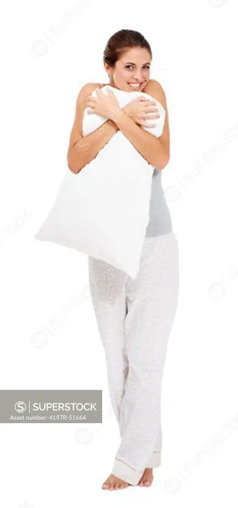 Full-length portrait of a young woman hugging her pillow