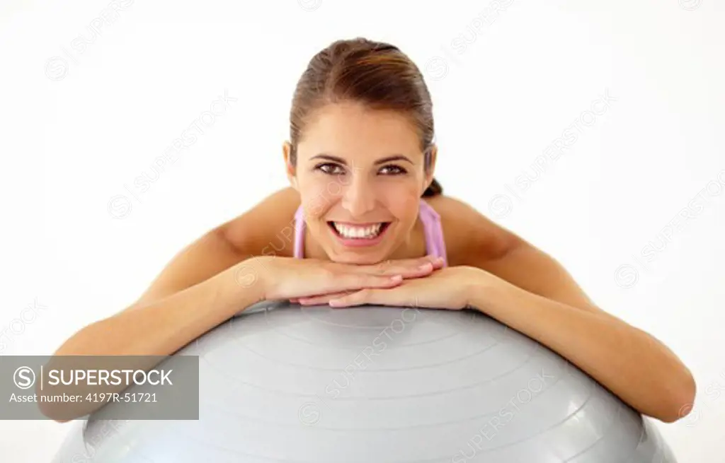 Portrait of a pretty young woman leaning over a swiss ball - Isolated on white