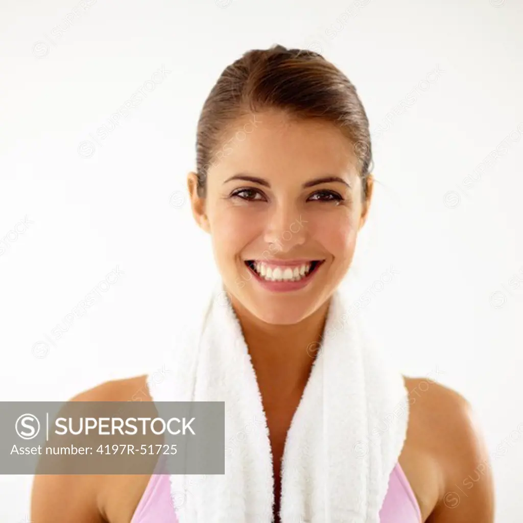 Fresh faced young woman with a towel around her neck ready for a gym session