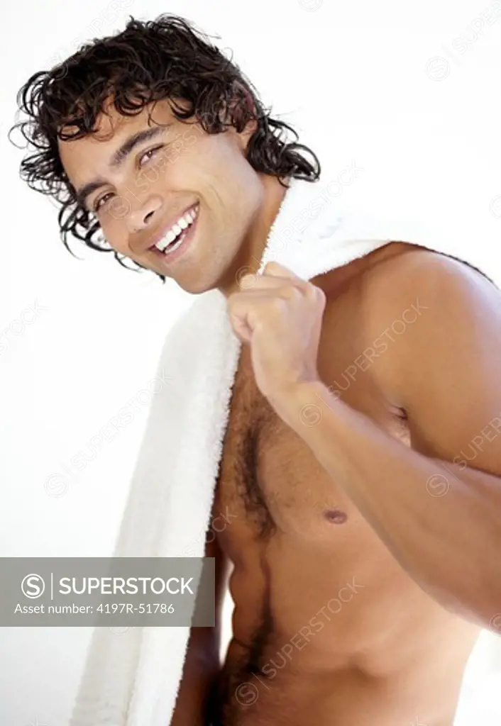 Portrait of a sexy young man drying himself after a refreshing shower