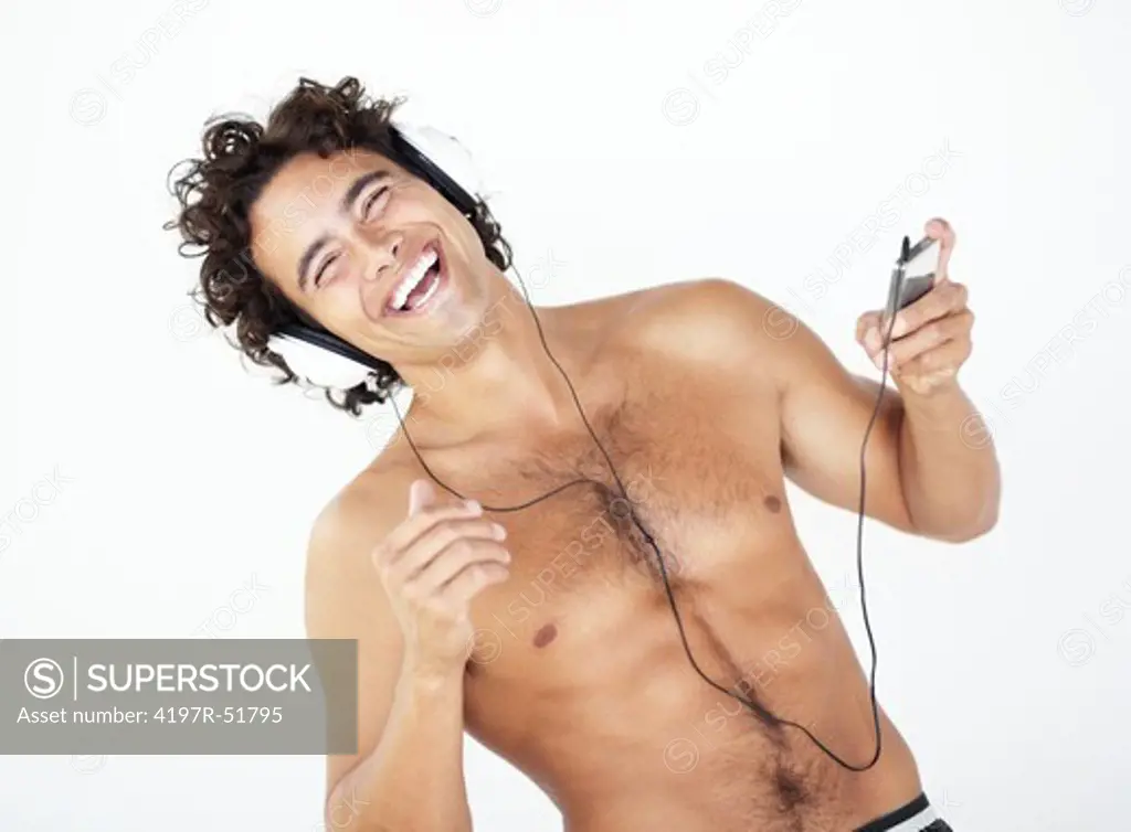 Portrait of a handsome young shirtless man listening to his mp3 player
