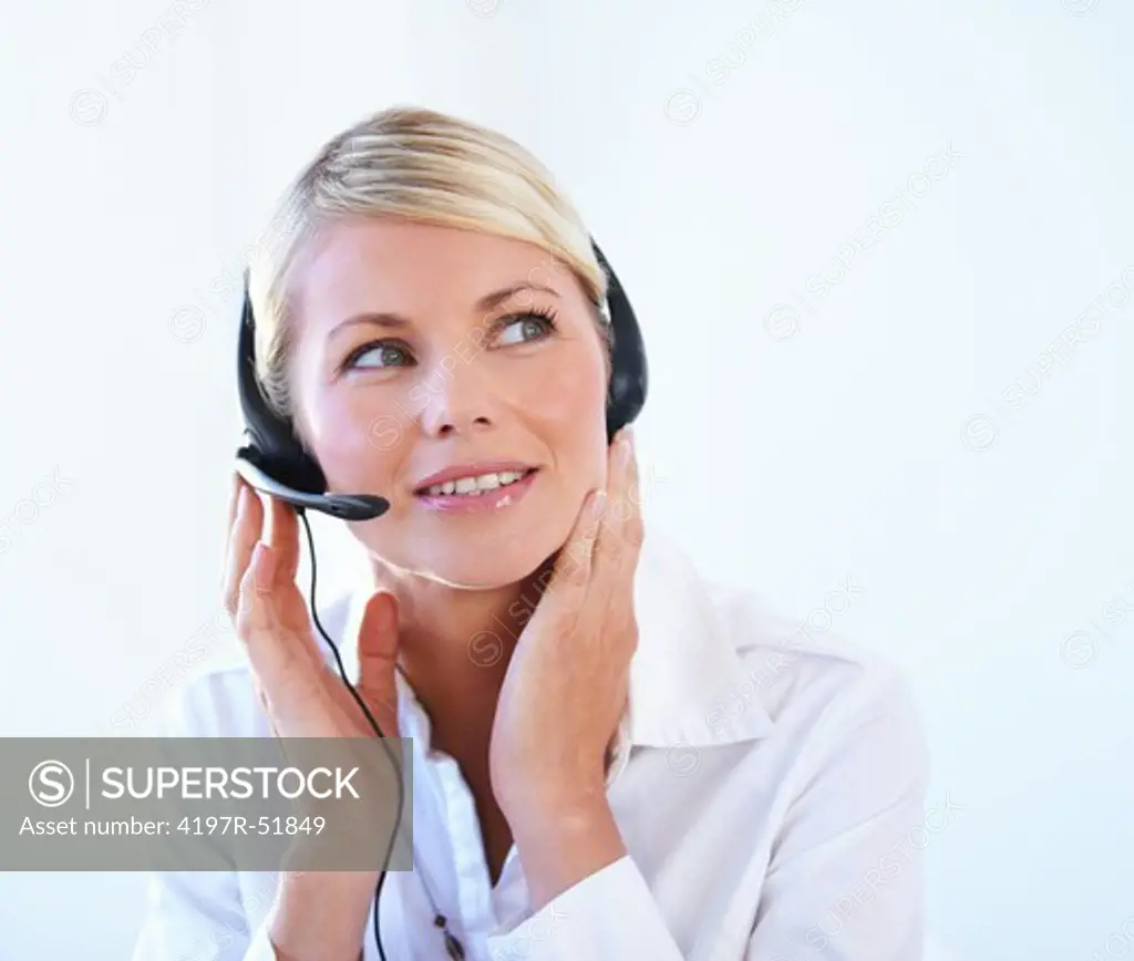 Thoughtful young call center agent wearing a headset - portrait
