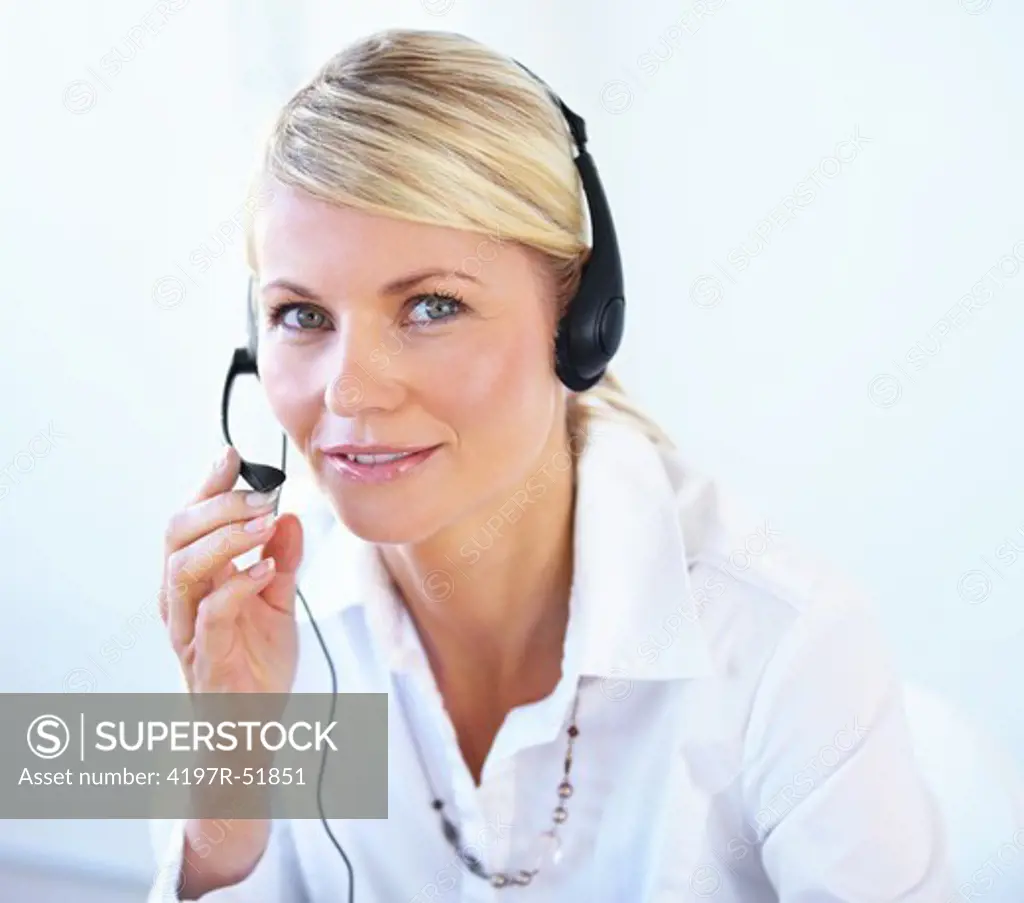 Attractive young call center agent wearing a headset - portrait