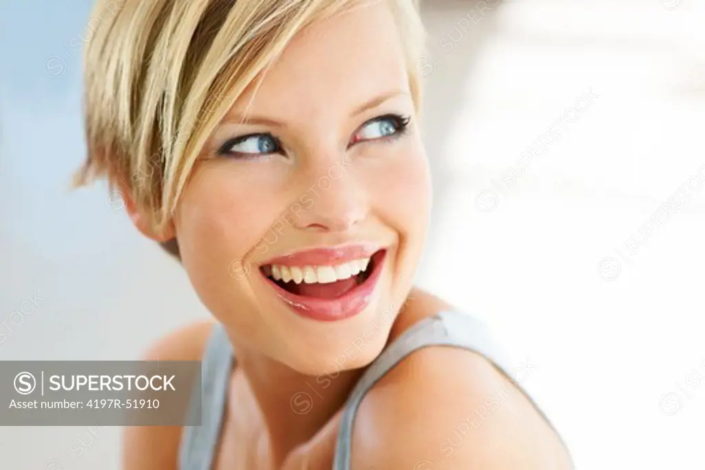 Cute young woman looking away as she has a gorgeous smile
