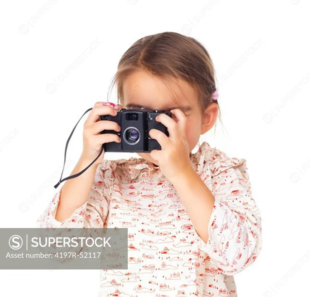 Young girl child trying to shoots photos with camera isolated on white background