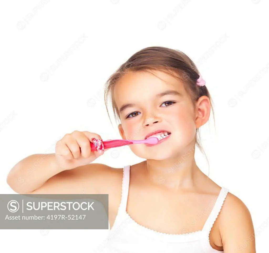 Pretty young girl brushing her teeth against white background