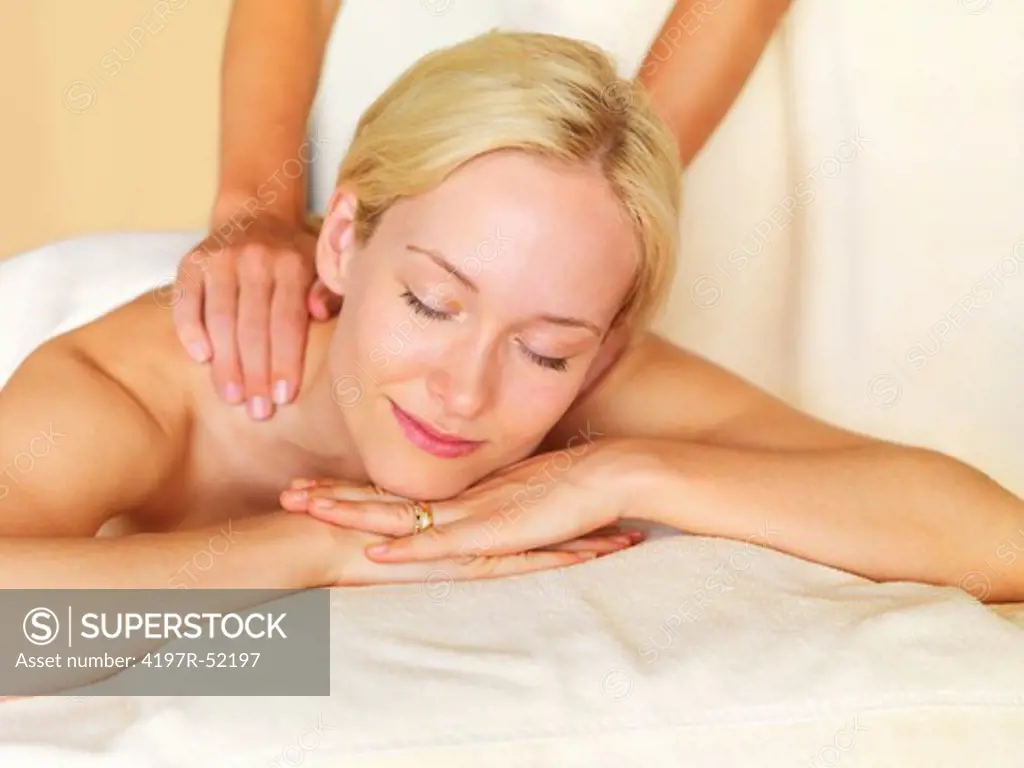 Gorgeous middle aged woman receiving back massage at spa