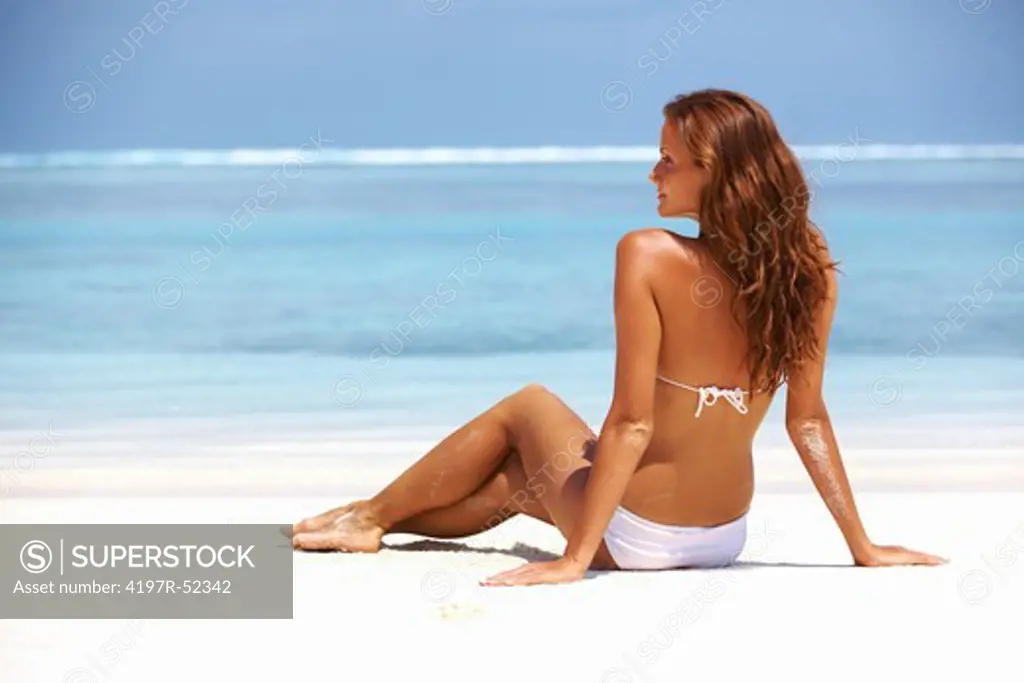 Portrait of beautiful young woman in bikini at beach