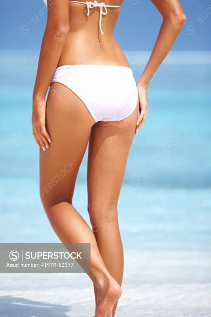 Portrait of young woman in bikini flaunting her buttocks