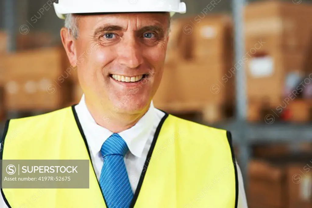 Portrait of a positive warehouse foreman smiling at work