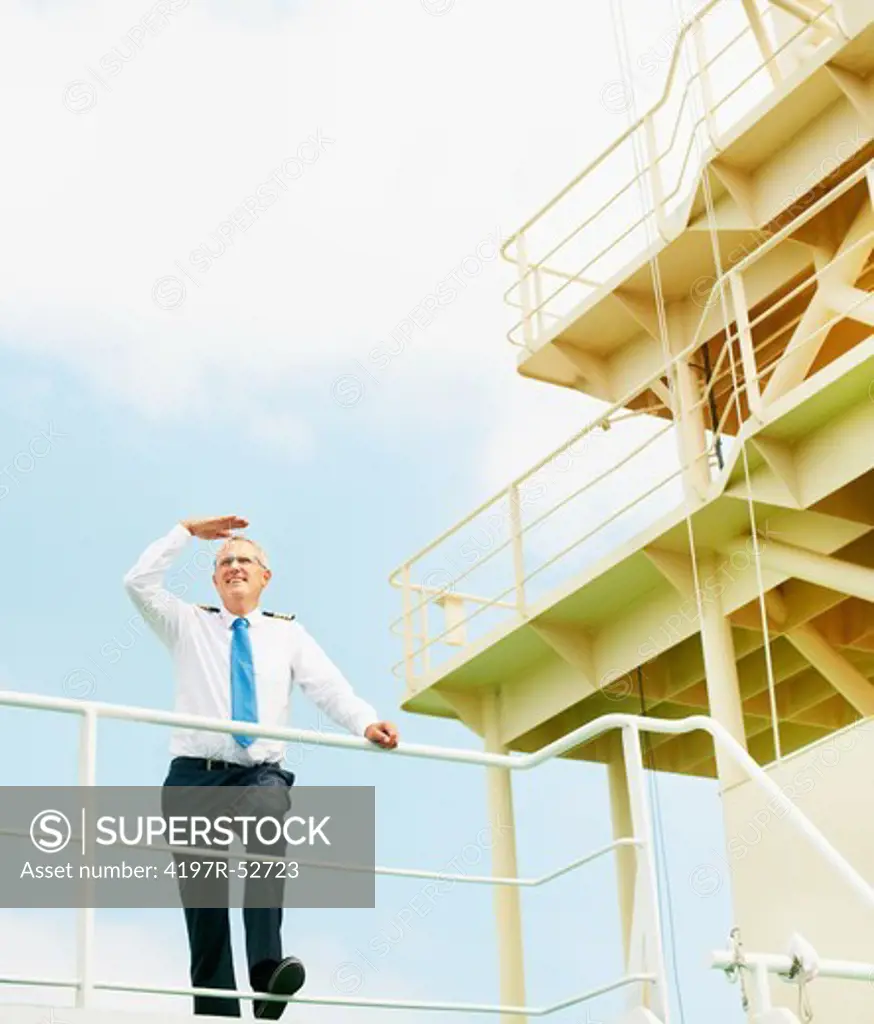 Mature shipmaster looking out from the deck of his ship