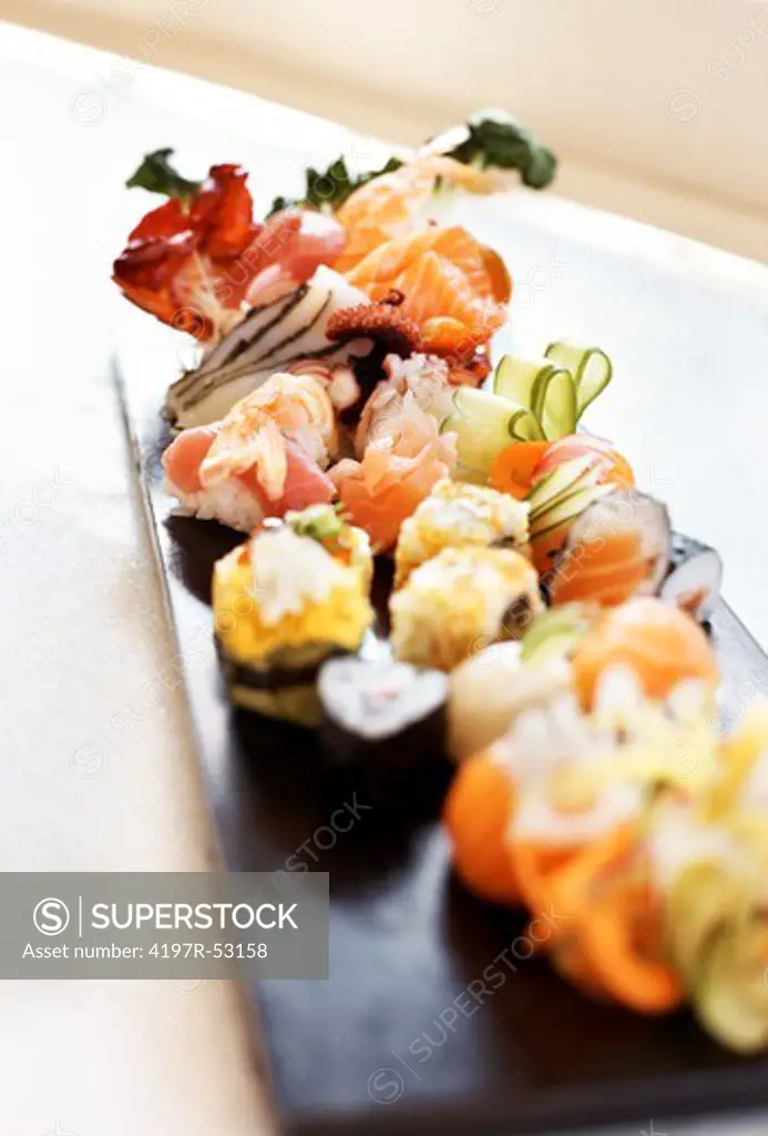 Sushi set - Different types of sushi served on wooden plate