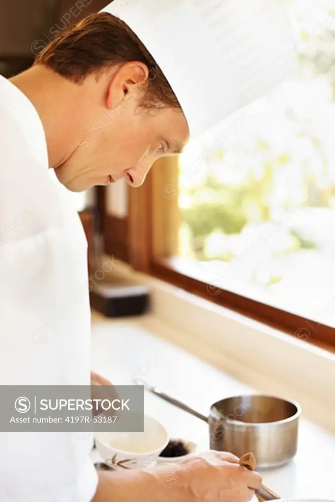 Closeup of male cook working in hotel kitchen